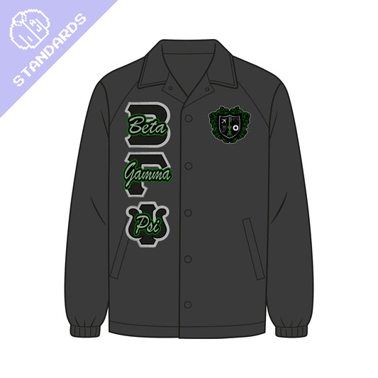 Standard Beta Gamma Psi line jacket. Jacket is a black coach jacket. The BGY crest is on the left chest. Silver, black, and green BGY fabric applique letters are on the left chest. The upper left corner has a purple badge showing this is the sorority's standard line jacket.